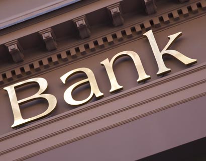 Image of the facade of a bank building, with the word