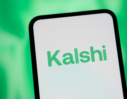 Phone screen with Kalshi written on it in green text.