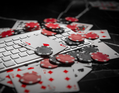 Gambling chips and cards on a keyboard.