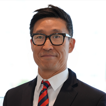 Image of Larry Lee, a man in a tie