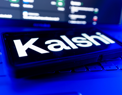 kalshi typed on phone on a laptop.